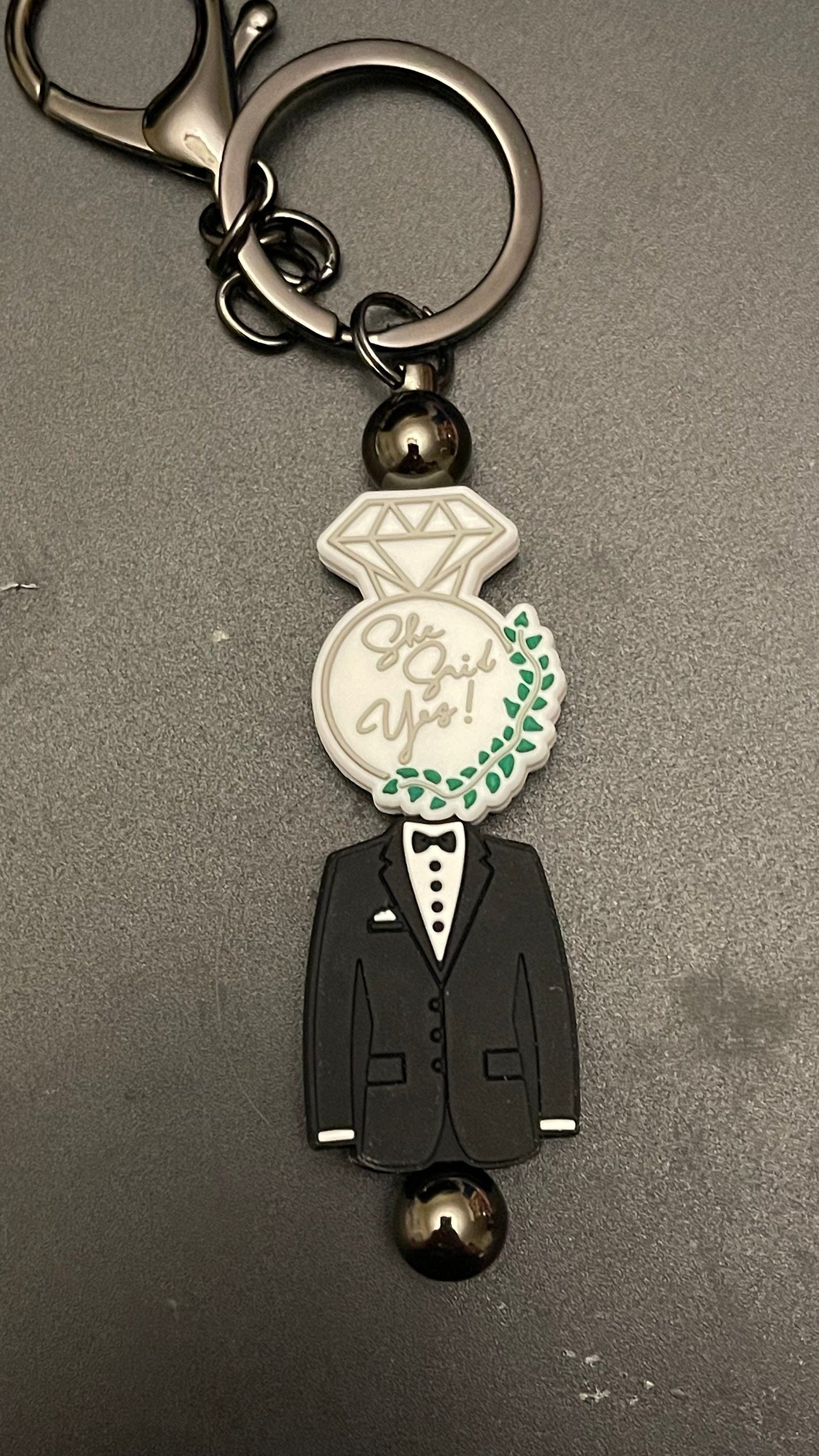 She said yes! tux keychain or zipper pull. Also can put on purses or backpacks or any bag!
