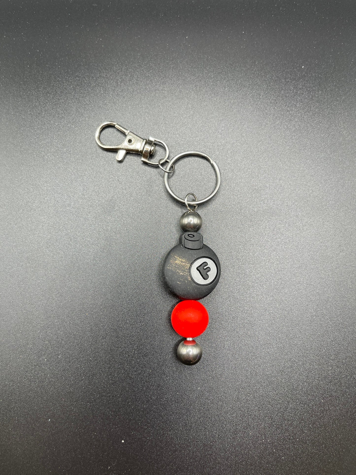 F bomb keychain or zipper pull. Also can put on purses or backpacks or any bag!