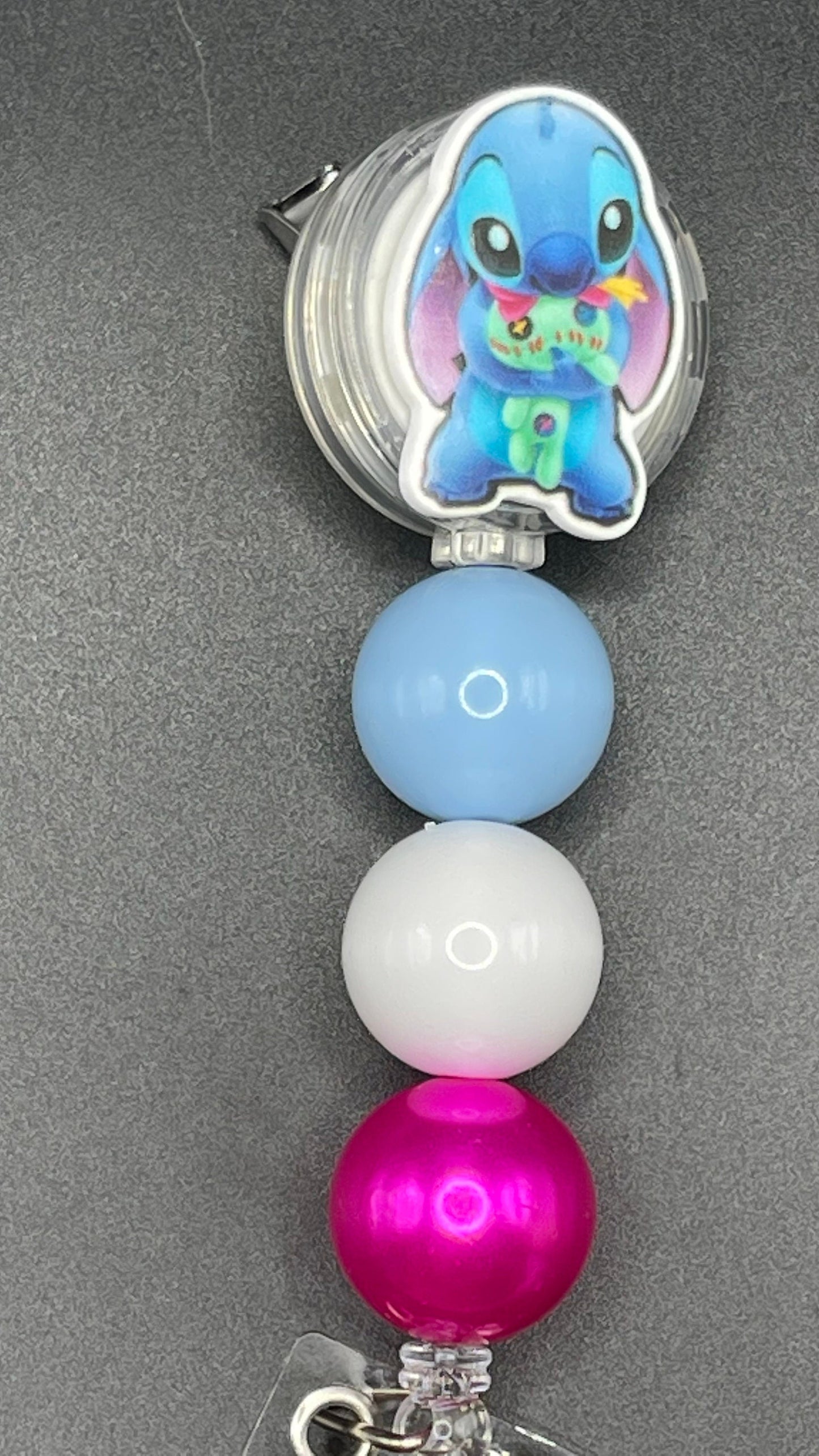 Stitch badge reel. Retractable with an alligator clip