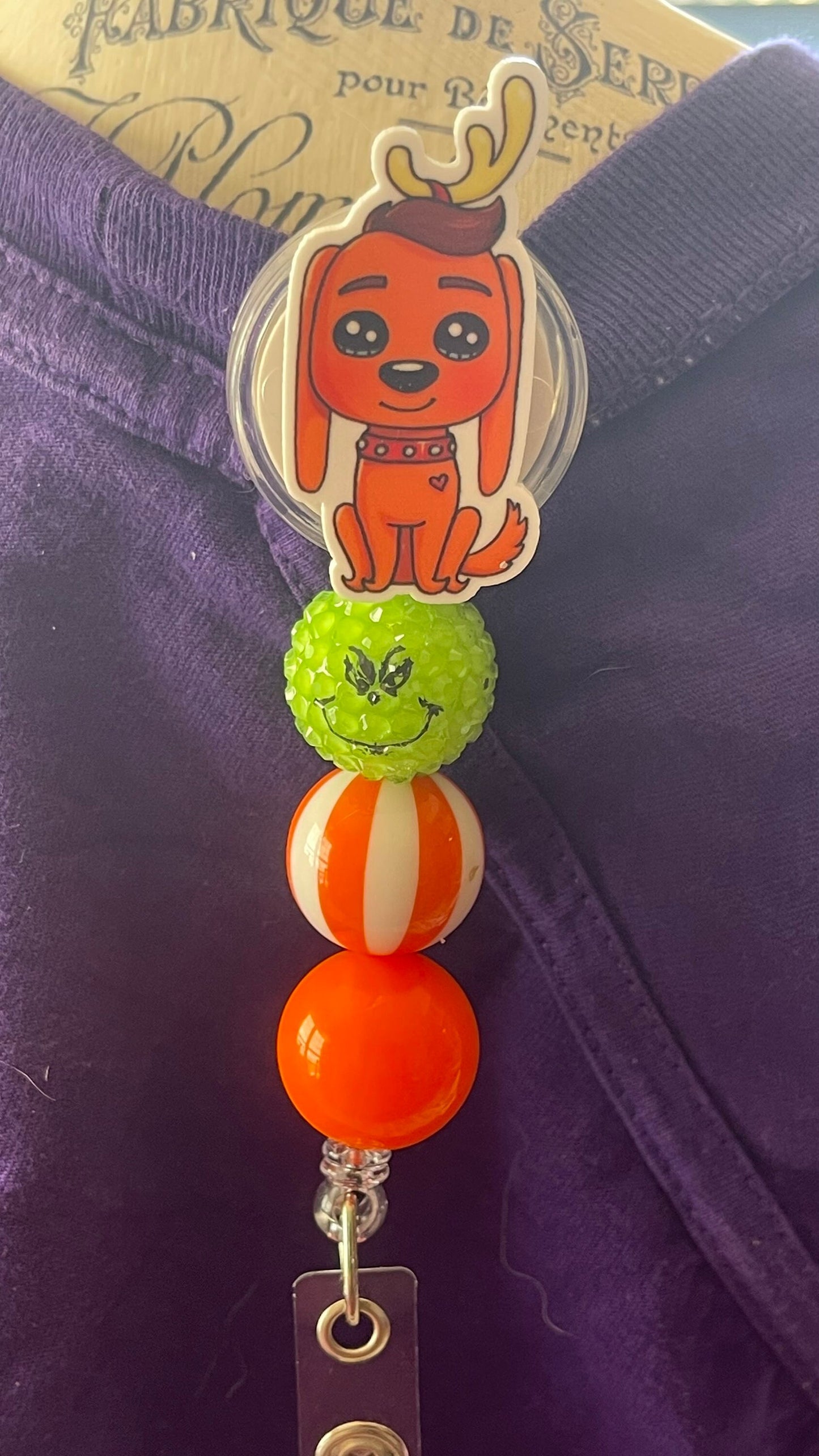 The Grinch dog Max badge reel. Retractable with an alligator clip