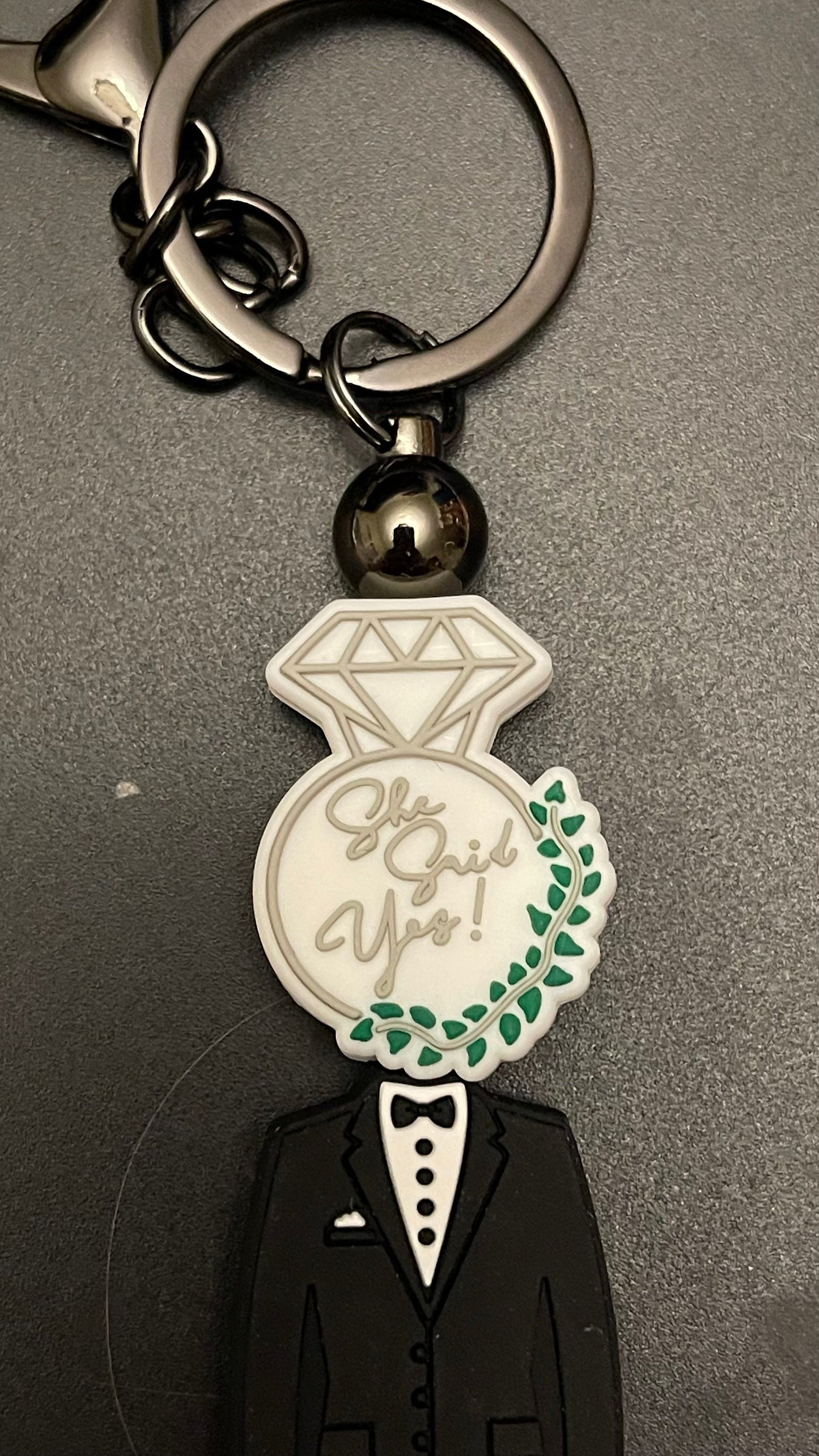 She said yes!  tux keychain or zipper pull. Also can put on purses or backpacks or any bag!