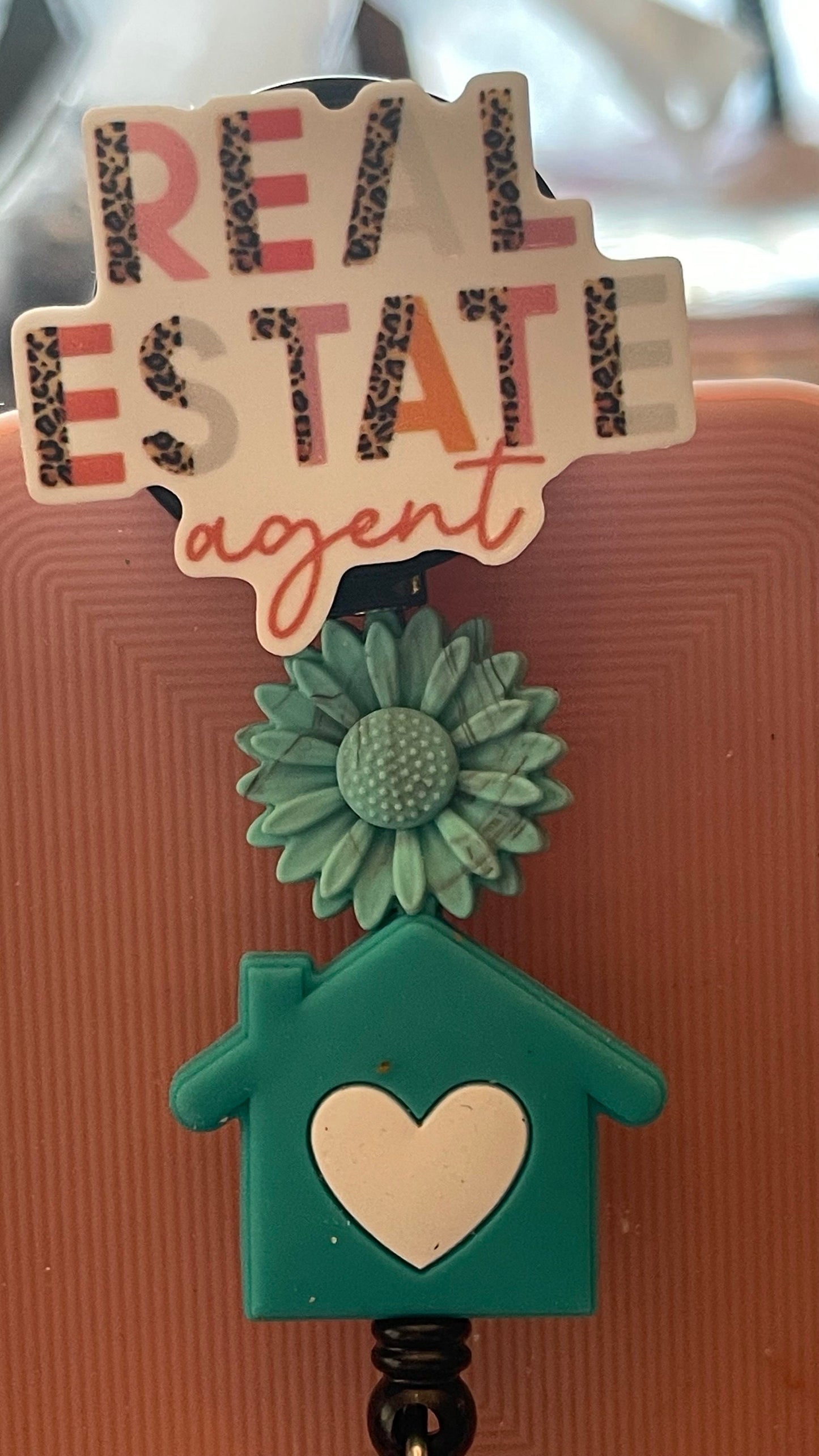 Real Estate Agent badge. Home is where the heart is