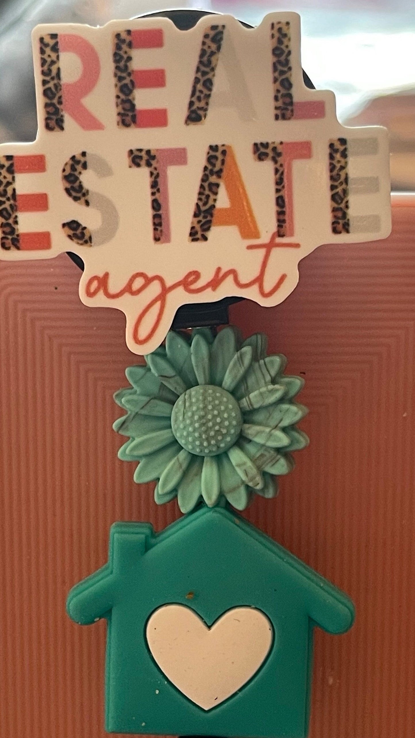 Real Estate Agent badge. Home is where the heart is